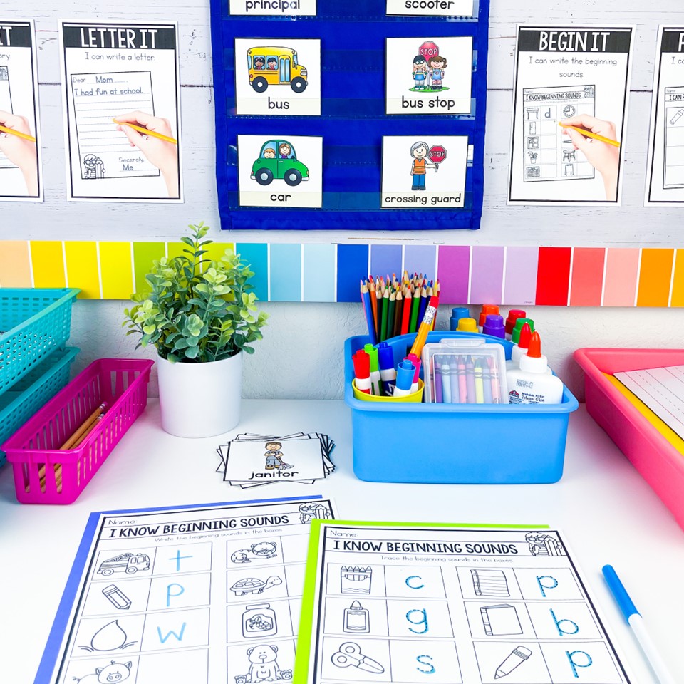Kindergarten writing center set up showing vocabulary cards in a pocket chart, I Can posters, and beginning sounds labeling