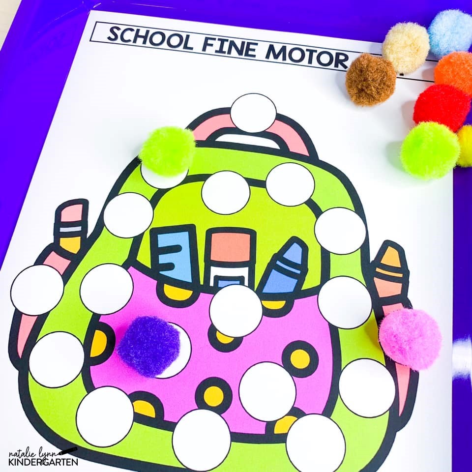 back to school fine motor mats matching pom-poms to a picture of a backpack