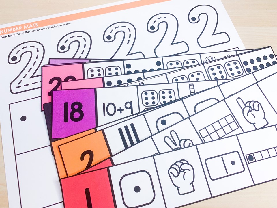 free number math centers for kindergarten | image shows number sense strips on top of a number trace and write mat