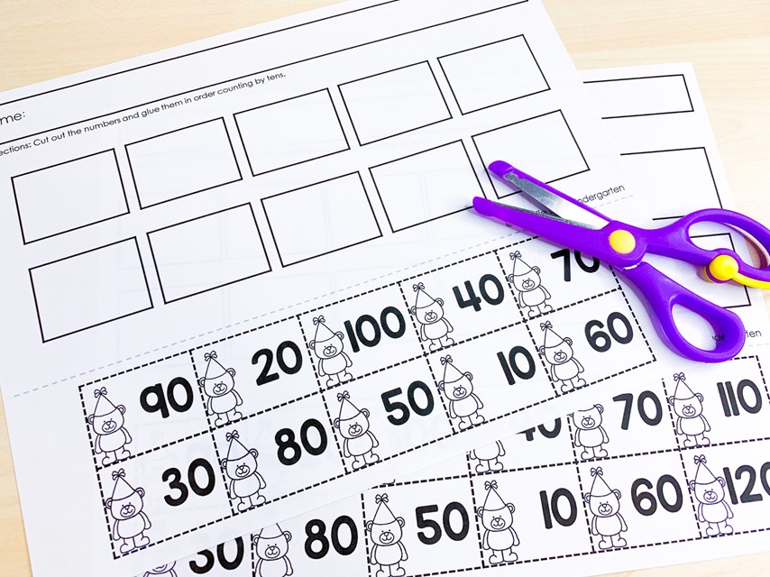 Free 100th Day of school Activities| Image shows counting by tens number order worksheets with purple scissors on top