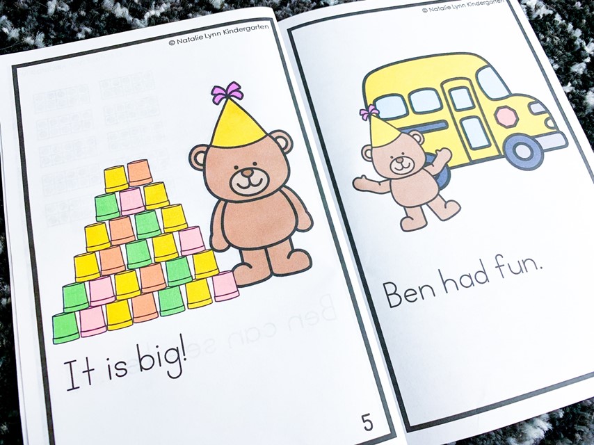 Free 100th Day of school Activities| Image shows a 100th day decodable reader book open. The first page shows a bear with a stack of cups and the sentence "It is big!" The second page shows a bear by a bus and the sentence "Ben had fun."