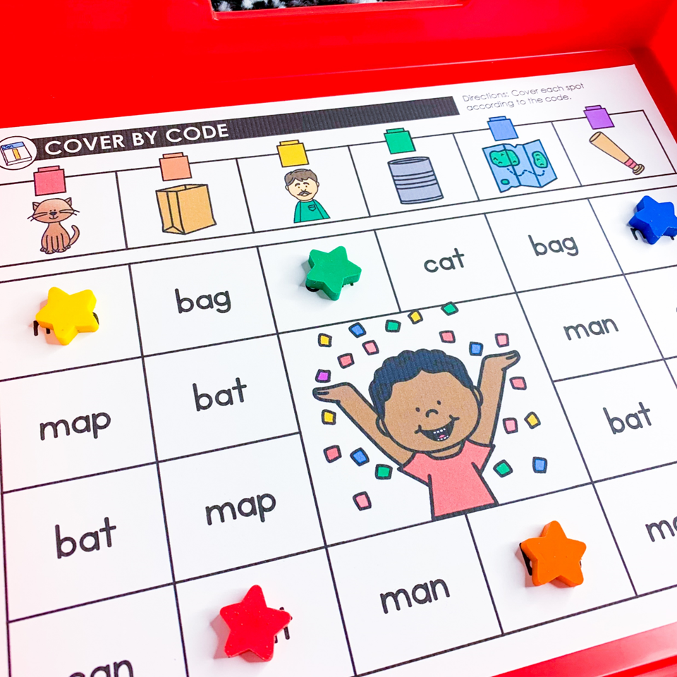 New Year's Eve literacy centers for Kindergarten | image shows a cover by code mat with CVC words on a red tray