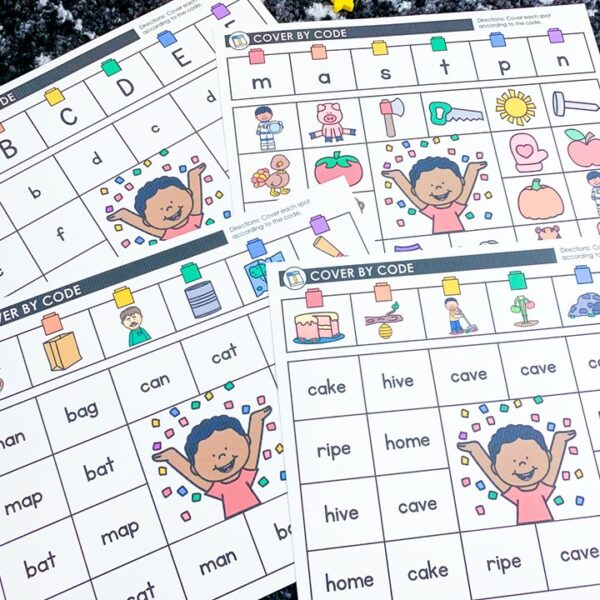 free new year centers for preschool ,pre-k, kindergarten and first grade | picture shows four cover by code mats on a black and white carpet.