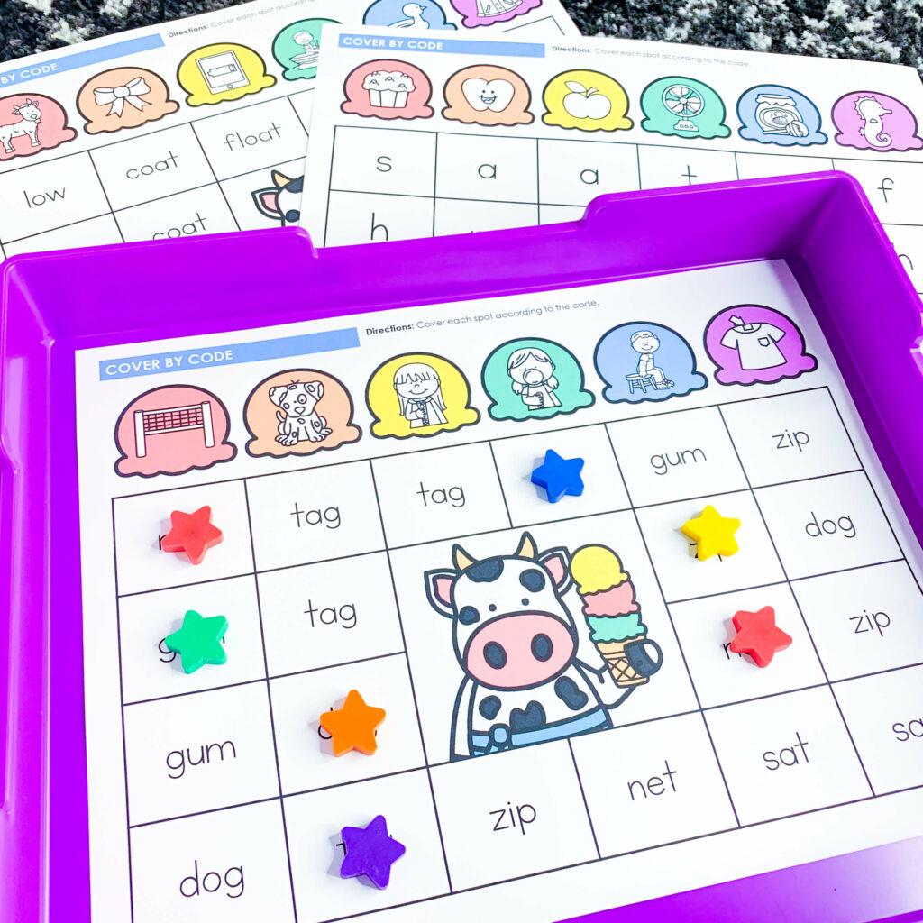 free end of the year ice cream theme days for kindergarten and first grade | image shows a cvc words cover by code activity on a purple tray with a vowel teams and beginning sounds cover by code layered behind the tray
