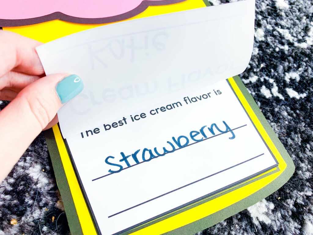 free end of the year ice cream theme days for kindergarten and first grade | image shows the ice cream writing craft being lifted to show the writing inside "The best ice cream flavor is strawberry."