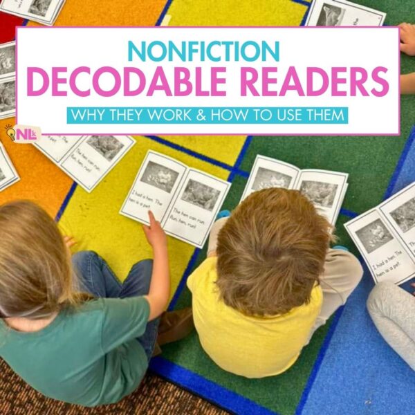 Two young students sitting on a colorful classroom rug reading nonfiction decodable readers during small group time